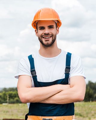 selective-focus-of-happy-repairman-standing-with-c-2022-11-02-01-58-52-KMXSH29.jpg